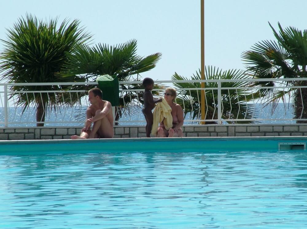 Photo of naturists in an outdoor pool - Human nature in its original form
